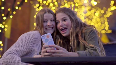 Teens Take Fun Selfies Together At Outdoor Cafe Stock Footage 61805412