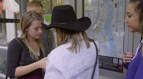 Teens use tablet computer to find directions Stock Footage 54090172