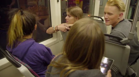 Teens using iPad on max train Stock Footage 54262315
