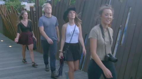 Teens walking along park path Stock Footage 54067740