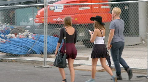 Teens walking by construction site Stock Footage 54060044