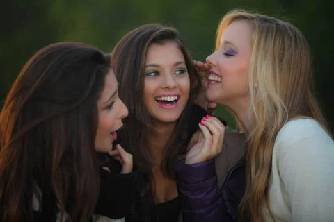 Teens whispering secrets Stock Photos
