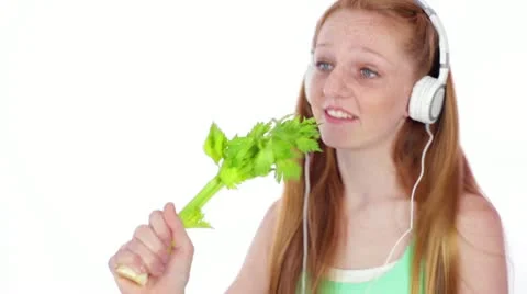 Teen/Tween with Headphones Sings into Celery Stalk Stock Footage 12533279