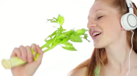 Teen/Tween with Headphones Sings into Celery Stalk Closeup Stock Footage 12533499