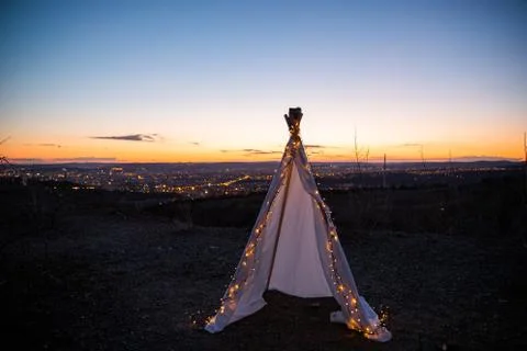 Teepee during dark sunset in quarry Hady Brno with view on city centre. Stock-Fotos