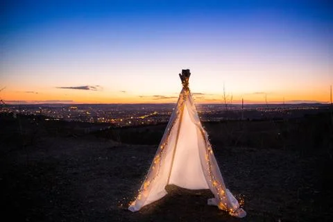 Teepee during dark sunset in quarry Hady Brno with view on city centre. Stock-Fotos