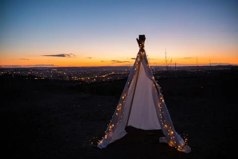 Teepee during dark sunset in quarry Hady Brno with view on city centre. Stock-Fotos