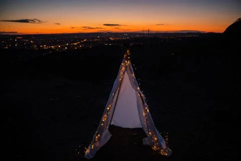 Teepee during dark sunset in quarry Hady Brno with view on city centre. Photos