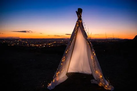 Teepee during dark sunset in quarry Hady Brno with view on city centre. Stock-Fotos