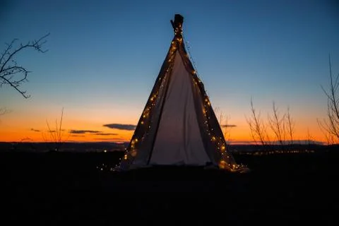 Teepee during dark sunset in quarry Hady Brno with view on city centre. Stock-Fotos