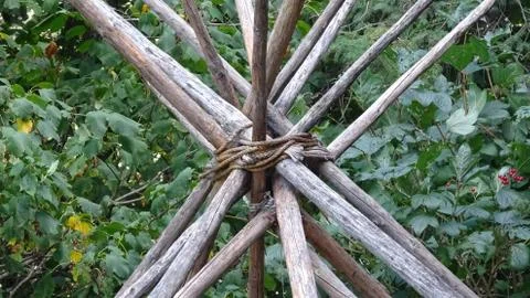 Teepee, sticks tied together in a triangular wooden frame 스톡 사진