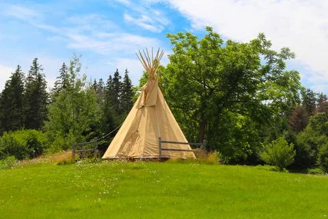 Teepee structure amongst green grass in New Brunswick Canada Stock Photos