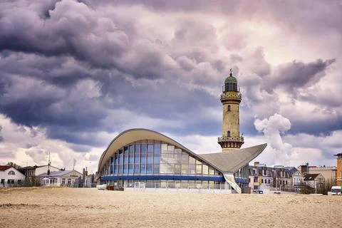 Teepott and lighthouse under dramatic clouds in Warnemunde. Stock Photos