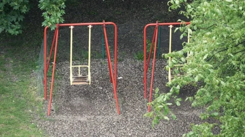 Teeter during bad weather and rain on street. Empty swing during the quarantine Stock-Footage 131338914