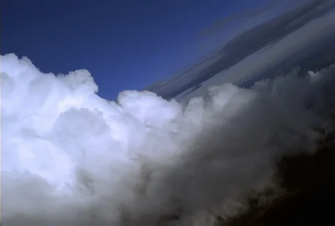 A teeter-tottering ride along the edge of a cloud begins with the plane tilted Stock Footage 86832341