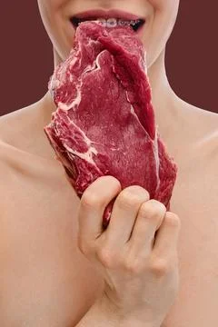 Teeth with dental braces bite raw beef meat Stock Photos