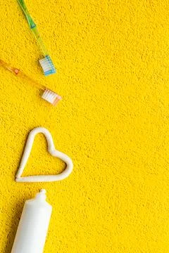 Teeth hygiene concept. Toothbrushes with toothpaste, top view Stock Photos