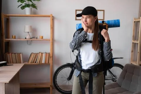 Teeth problem. traveler hiker with backpack feeling tooth pain at home. Den.. Stock Photos