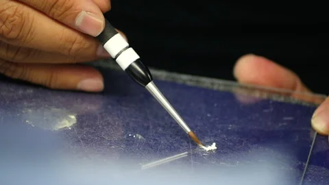 Teeth technician. Dental craftsman using a brush to pick up ingredients for a Stock Footage 140280881