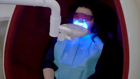 Teeth whitening procedure with ultraviolet light UV lamp Stock Footage 106204428