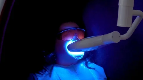 Teeth whitening procedure with ultraviolet light UV lamp Stock Footage 106204481