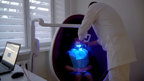 Teeth whitening procedure with ultraviolet light UV lamp Stock Footage 106204542