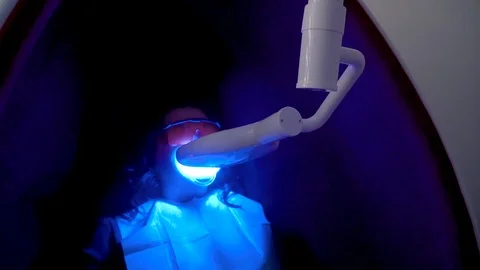 Teeth whitening procedure with ultraviolet light UV lamp Stock Footage 106247238