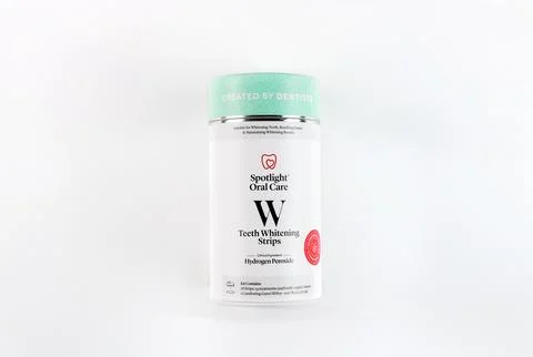 Teeth whitening strips in container designed for effective at-home dental care Stock Photos