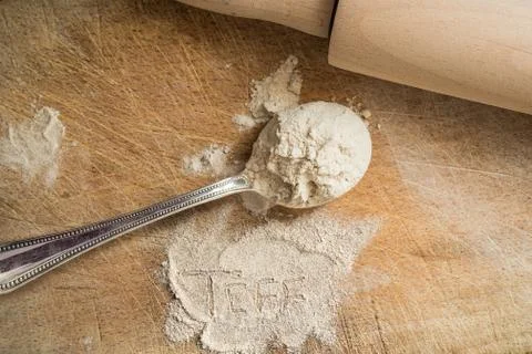 Teff flour on a spoon with a rustic background Stock Photos
