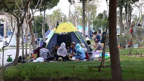 Tehran, Iran - March 27, 2018: Iranian travelers living in tents on the beach at Stock Footage 106942018