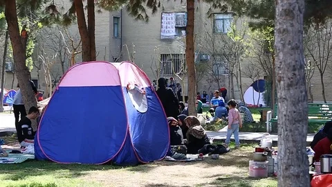 Tehran, Iran - March 27, 2018: Iranian travelers living in tents on the beach at Stock Footage 106942484
