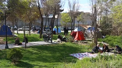Tehran, Iran - March 27, 2018: Iranian travelers living in tents on the beach at Stock Footage 106943053