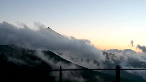 Teide peak above clouds with glowing sunset Stock Footage 334975552
