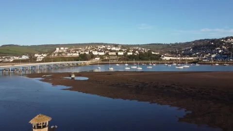 Teignmouth, Devon, England: Drone View, Zoom Out: River Teign, mudflats &amp; bridge Stock Footage 168567495