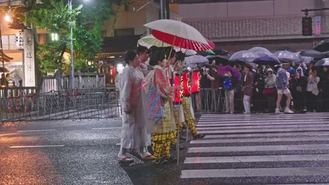 Tekkomai Dancers in Patterned Kimono Hold Red Lanterns Under Parasols at Rainy Stock Footage 337551037
