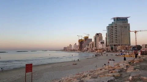 Tel-Aviv beach at sundown, high rises, cranes, Mediterranean, people, Israel Vídeos de archivo 76492169