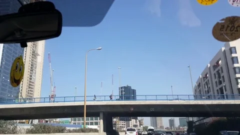 Tel-Aviv high rises, highway, shot in motion through windshield of car, bridge Stock Footage
