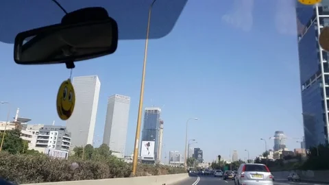 Tel-Aviv high rises next to highway, shot in motion through windshield of car Видео 80595257