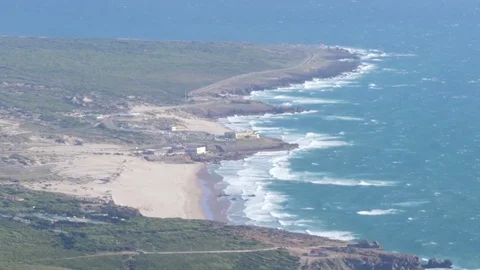 Tele shot coastline beach cliffs waves 4k Stock Footage 77768581