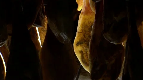 Tele unique detailed shoot of rack full of ham legs hanging in a industry Stock Footage 202521367