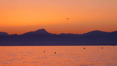 Tele view of Airplane is passing by in sunset at El Arenal, Mallorca, Spain Stock Footage 86179988