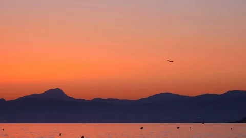 Tele view of Airplane is passing by in sunset at El Arenal, Mallorca, Spain Stock Footage 86180469