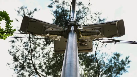 Telecom equipment on a pole with trees in the background, showcasing modern Stock Footage 277846868