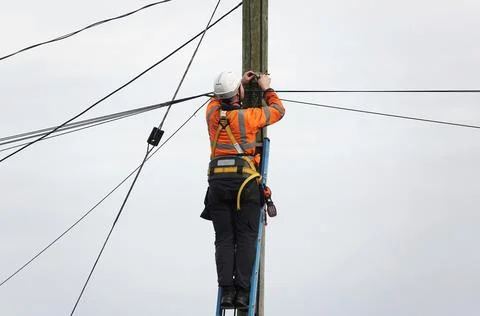 A telecom Openreach engineer working on a telegraph pole in the United Kingdom Stock Photos