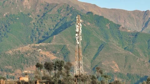 Telecom tower against rugged Himalayan mountains at sunset in India Vídeos de archivo 348084553