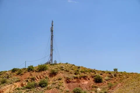 Telecom tower on barren hillside Stock Photos