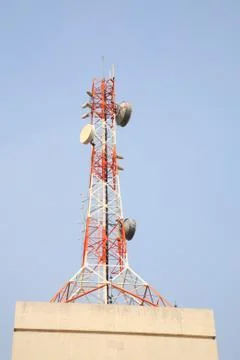 Telecom tower on top of building Stock Photos