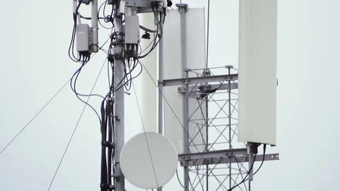 Telecommunication antenna in the background of a cloudy sky. Birds are hovering Video stock 80992107