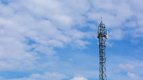 Telecommunication antenna on blue sky with clouds background Stock Footage 58738571