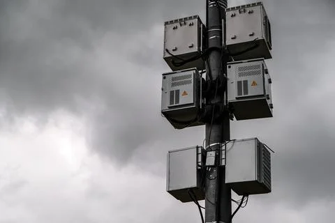 Telecommunication Base Station with a Cloudy Background and Urban Environment Stock Photos